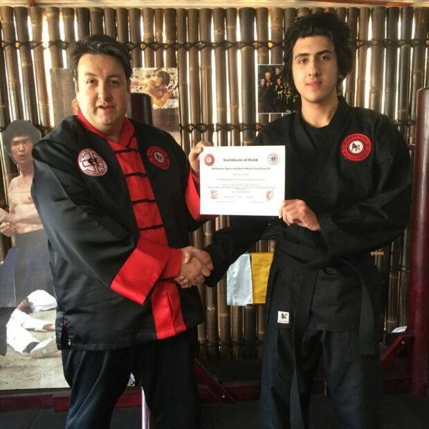 Martial Arts Mastery Sifu Maurice Novoa certifying his student to to black belt